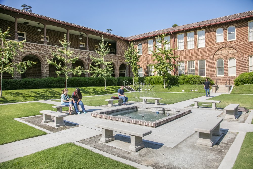 students sitting in courtyard