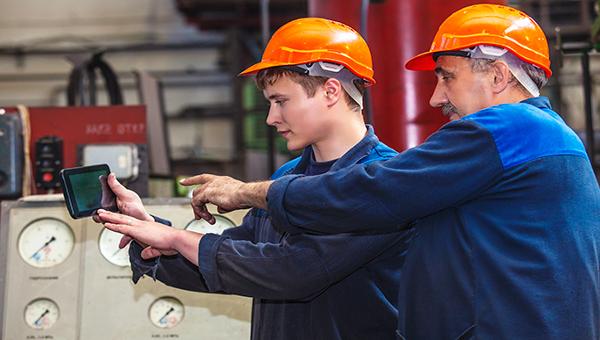 Safety workers checking informational tablet