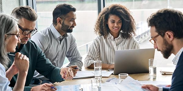 employees sitting around desk