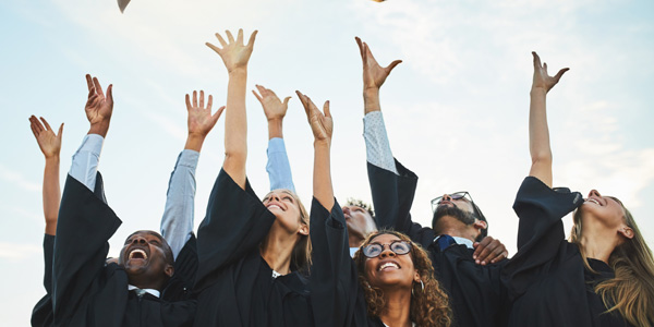 graduates throwing their caps