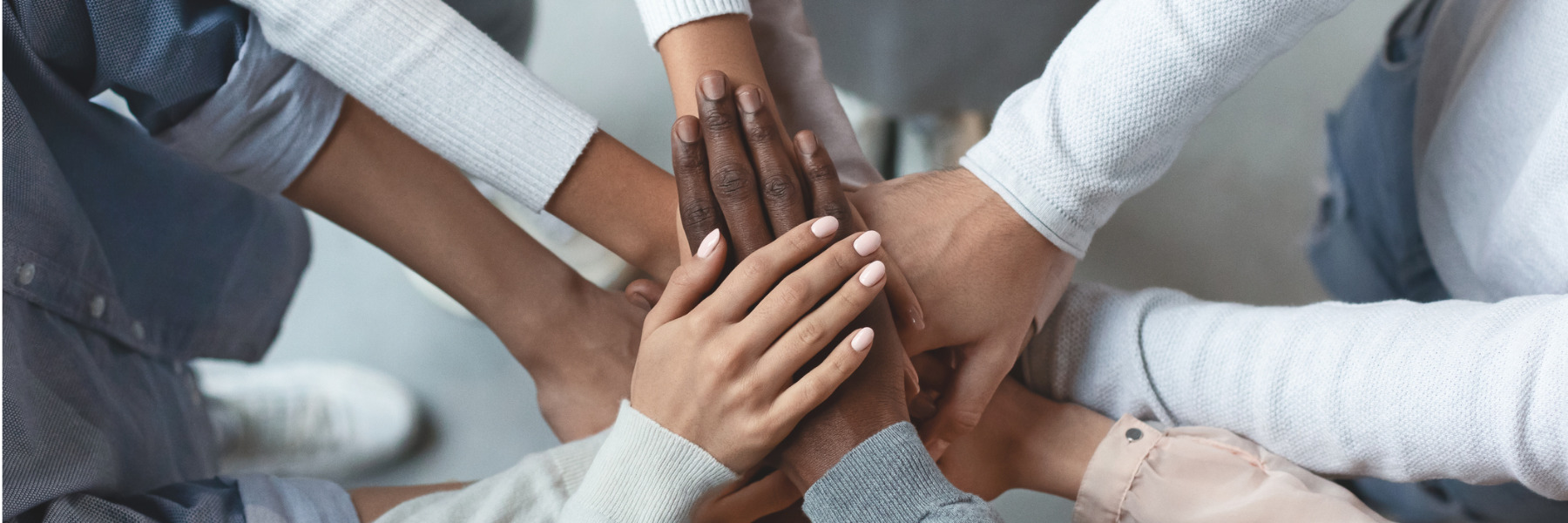 multi racial business team with hands stacked