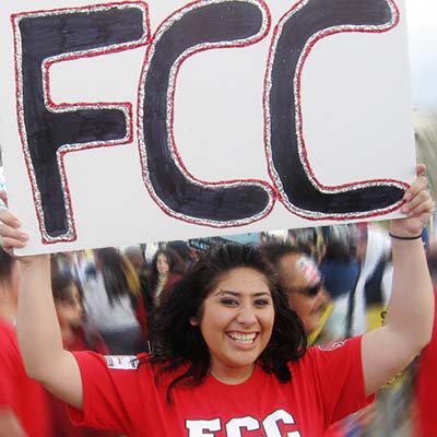Student holding sign with FCC painted on it