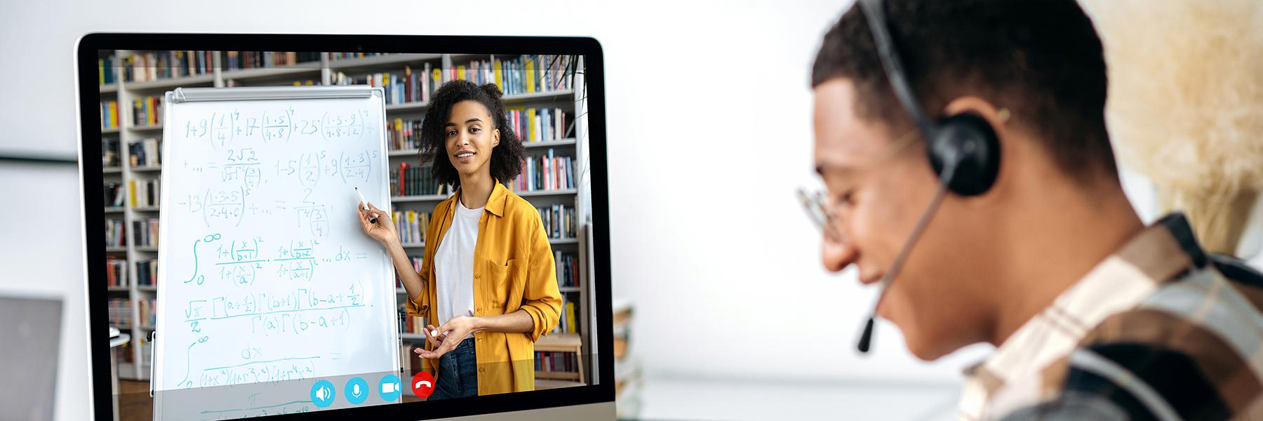 student watching teacher on his computer