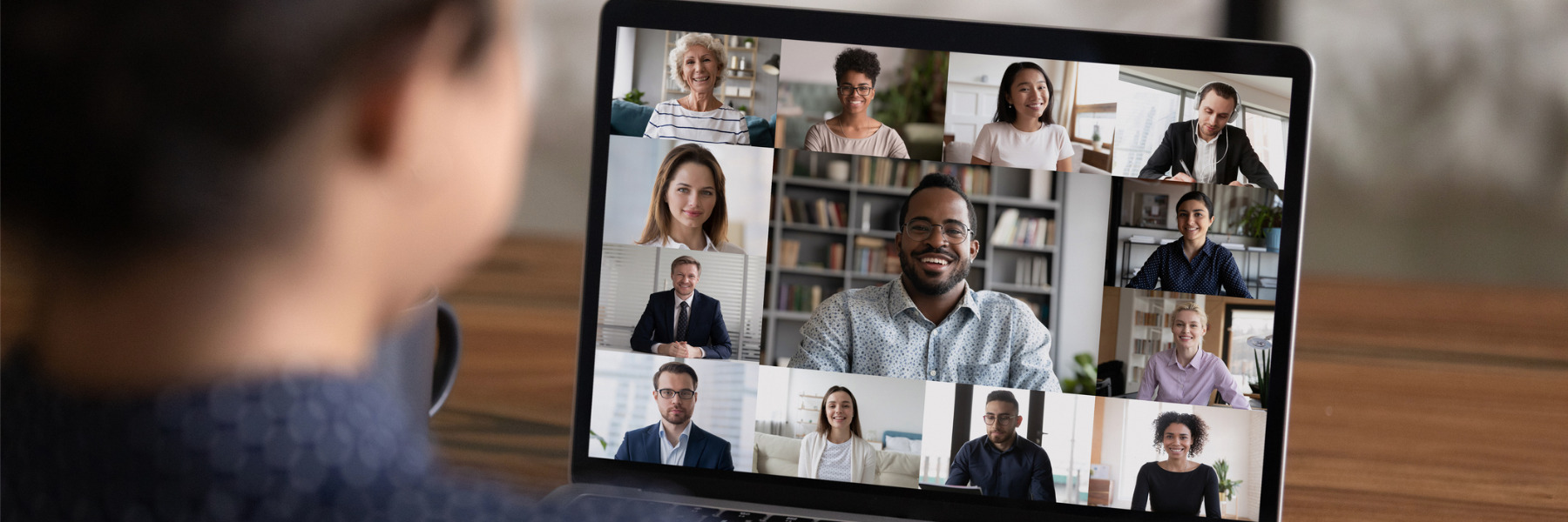 person attending virtual meeting on laptop.