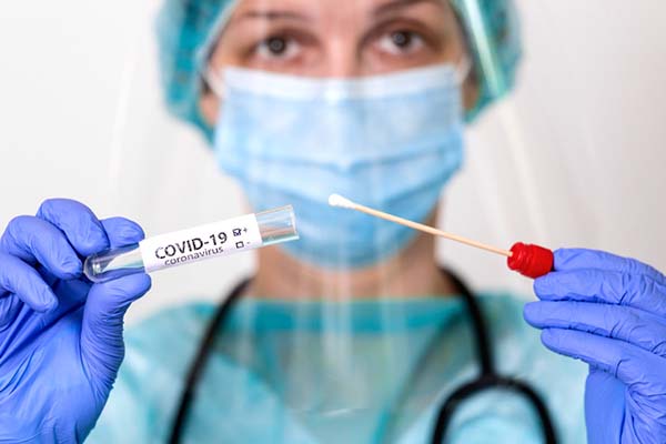 medical worker holding covid19 swab kit